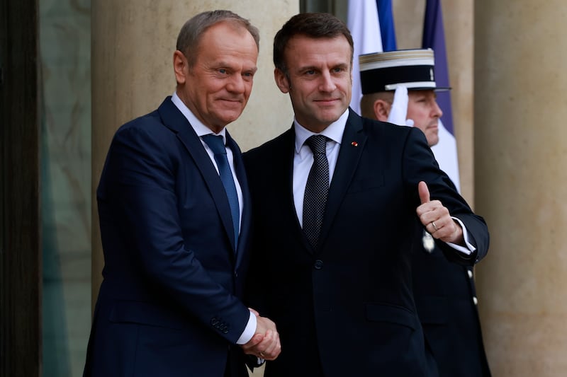 French President Emmanuel Macron, right, welcomes Poland’s Prime Minister Donald Tusk at the Elysee Palace in Paris (Aurelien Morissard/AP)