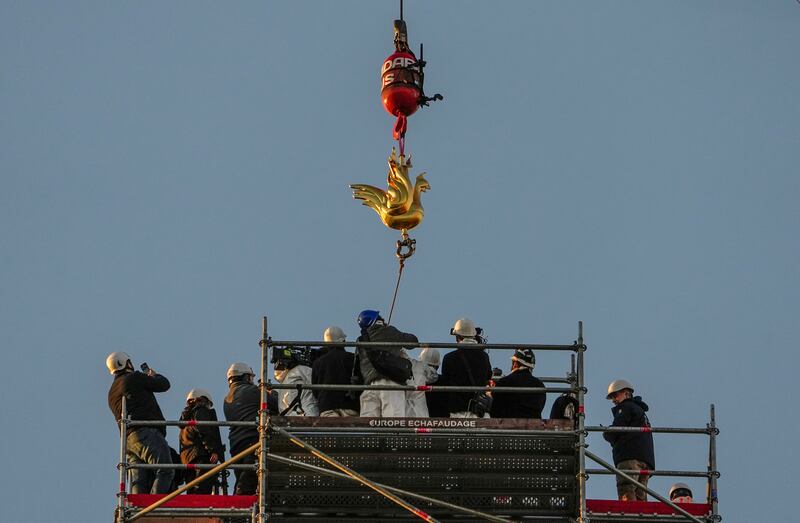 The rooster is lowered onto the cathedral’s spire (AP Photo/Michel Euler)