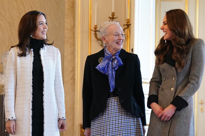 The then Duchess of Cambridge is welcomed by Queen Margrethe II (centre) and Crown Princess Mary of Denmark during a visit in 2022