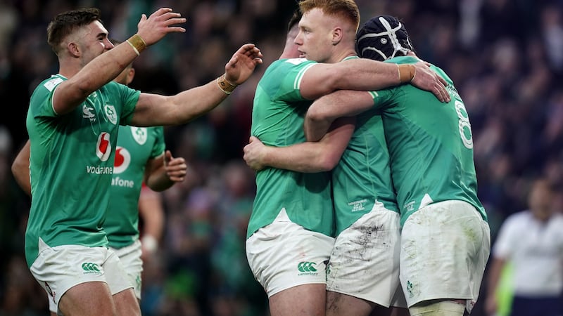 Ciaran Frawley (centre) celebrates with Ireland team-mates after scoring against Wales