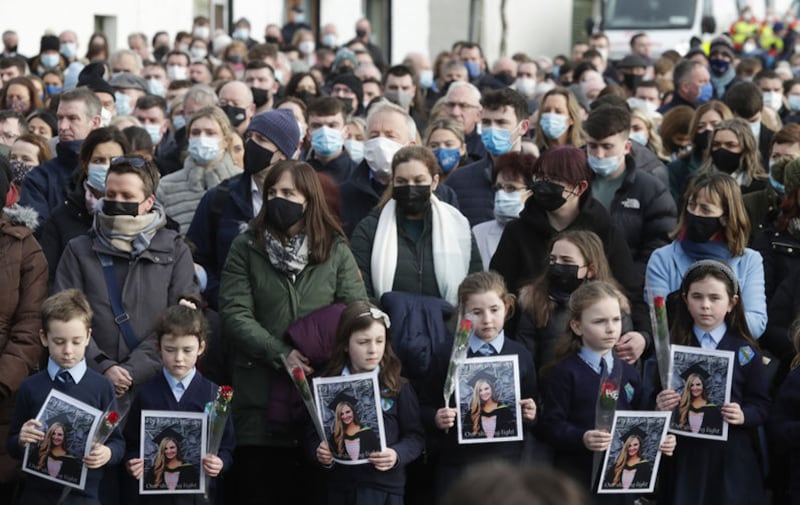Schoolchildren taught by Ashling Murphy hold photographs of her as the cortege passes by on arrival at St Brigid's Church, Mountbolus, Co Offaly. Picture by Niall Carson/PA Wire&nbsp;