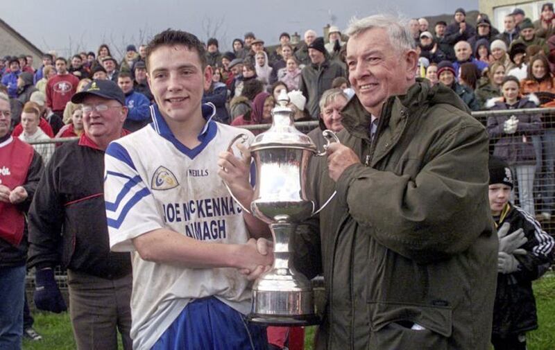 John O&#39;Reilly, who was chairman of the Ulster Council from 2001-2004, presents Armagh Harps captain Joe Quigley with the Dale Farm Ulster Minor Club Championship Trophy. Photo by Seamus Loughran 