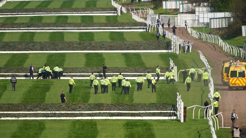 Police officers responding to Animal Rising activists attempting to invade the race course ahead of the Randox Grand National Handicap Chase 2023