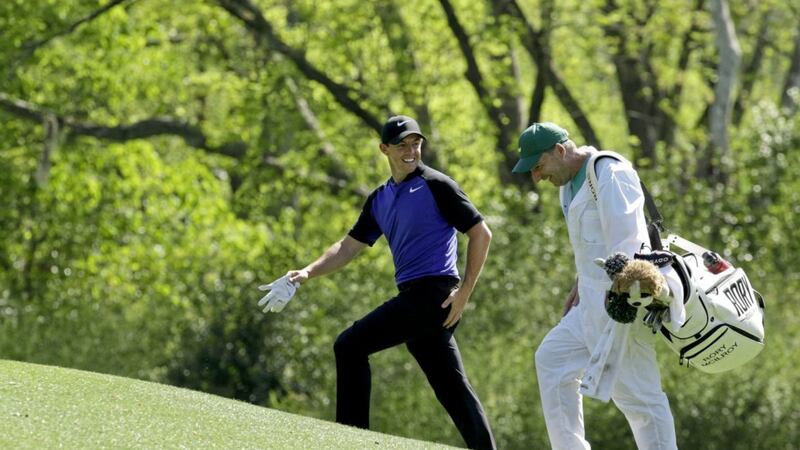 Rory McIlroy talks to his caddie while walking to the 12th hole during a practice round for the Masters on Tuesday 