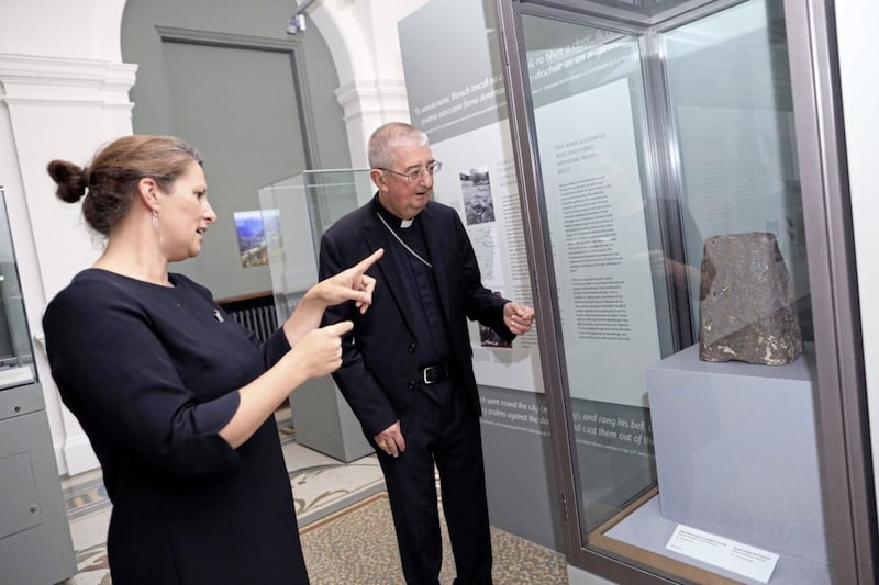 Lynn Scarff, director of the National Museum of Ireland, and Archbishop of Dublin Diarmuid Martin look at a bronze-coated iron hand-bell, dated to the 8th or 9th century. It was found near Glendalough and recently donated to the museum by the Archbishop of Dublin on behalf of the diocese. Picture by Julien Behal Photography 