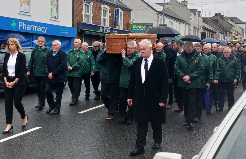 The remains of Declan Quinn are carried by former teammates along Ballygawley Main Street