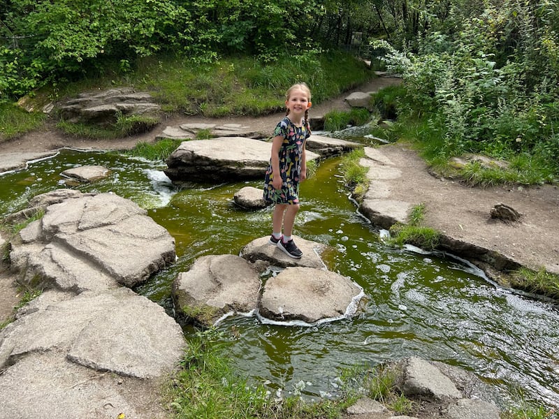Evie Johnson, 6, on the stepping stones near the silverback gorilla enclosure at Givskud Zoo, Denmark.