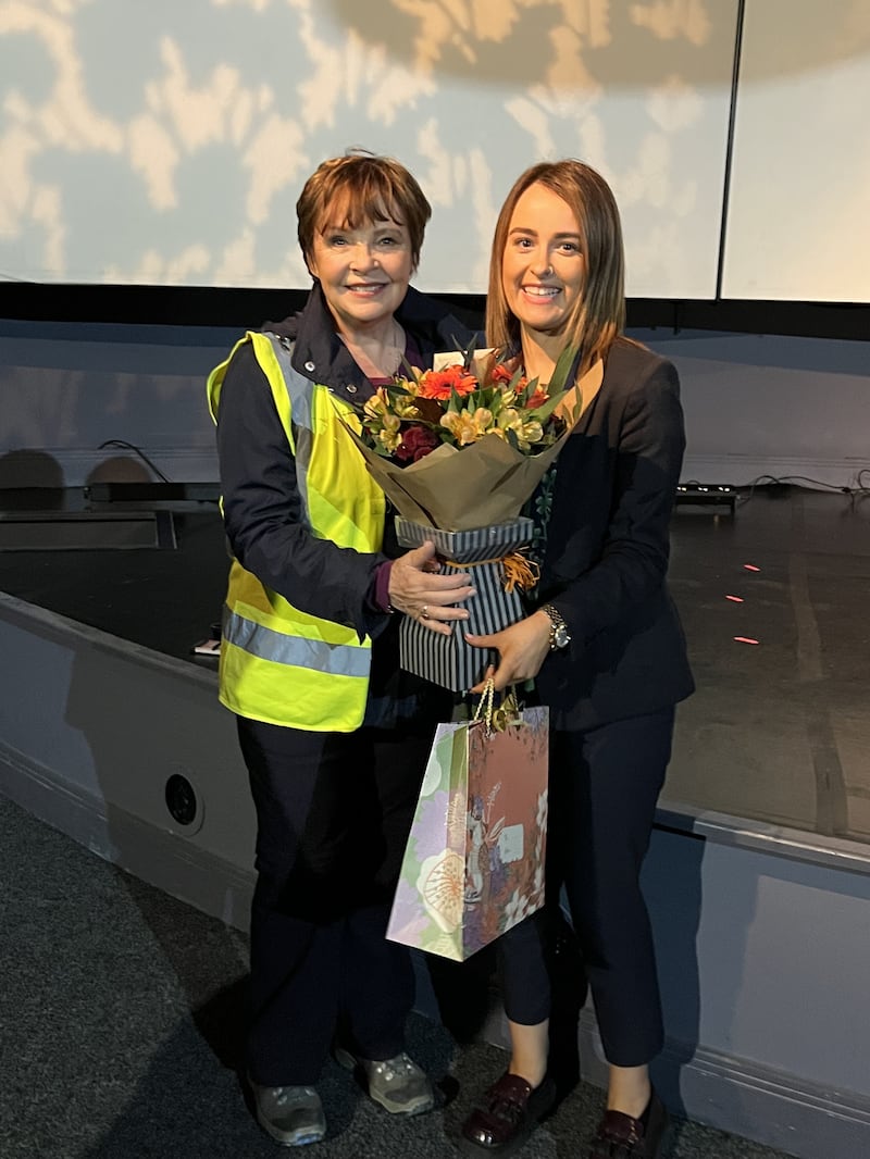Dana receives flowers and gifts from Chloe Stevenson, duty manager at the Saint Patrick Centre in Downpatrick. Picture: Neal Barclay