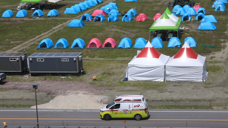 An ambulance passes a scout camping site during the World Scout Jamboree in Buan, South Korea (Jeonbuk Fire Station/Yonhap via AP)
