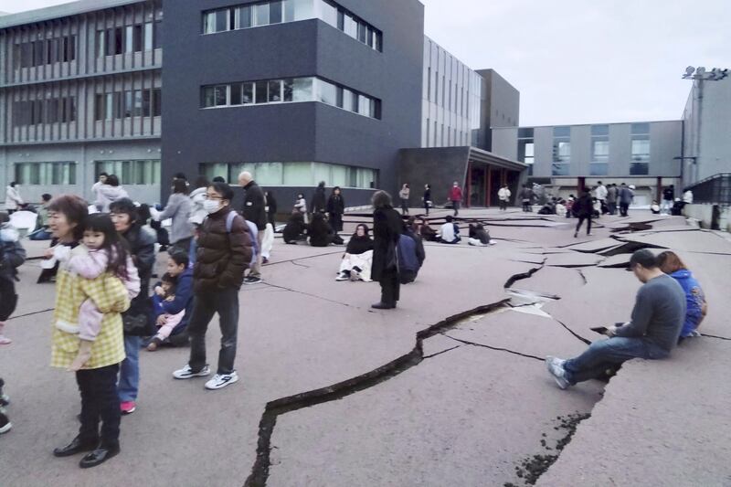 Cracks appear in the ground in Wajima, Ishikawa prefecture, following an earthquake (Kyodo News/AP)