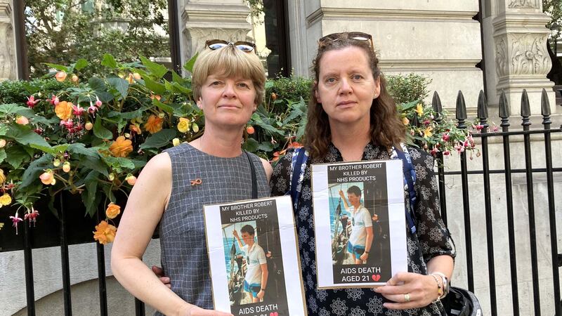 Liz Gardner (left) and Meg Parsons holding pictures of their brother Robert Gibbs outside the Infected Blood Inquiry in London. Mr Gibbs died aged 21 after finding out he was HIV positive aged 15. Picture date: Wednesday July 26, 2023. (PA)