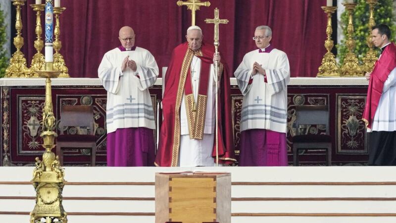 Pope Francis, centre, stands by the coffin of late Pope Emeritus Benedict XVI during a funeral mass at the Vatican. (AP Photo/Antonio Calanni). 