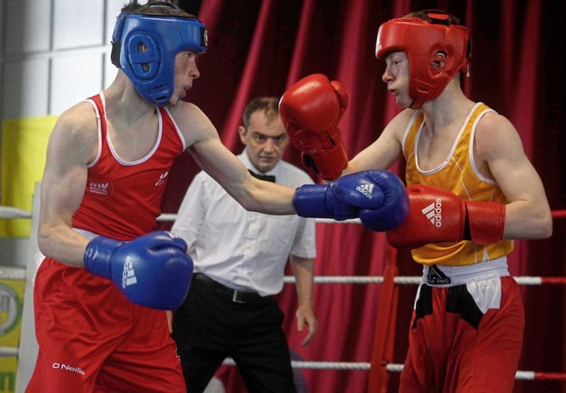 Referee Eugene O&rsquo;Kane, from Oakleaf boxing club in Derry, keeps a close eye on proceedings as Liam Casey (left) and Brendan Walsh of Holy Family go toe-to-toe during Saturday&rsquo;s Co Antrim v Donegal/Derry show at Corpus Christi boxing club. Antrim&rsquo;s Walsh went on to win the bout on a 3-2 split decision. Other results - Boy 4 52kg: A Scott (Antrim) bt J Gallagher (Donegal) RSC1; Boy 4 54kg: M Dineen (Derry) bt R Mitchell (Antrim) 3-2; Boy 4 66kg: K Cunningham (Donegal) bt A Foster (Antrim) 5-0; Boy 5 50kg: C Curley (Antrim) bt J Clarke (Donegal) 5-0; Boy 5 50kg: S Hillick (Antrim) bt M Templeton (Derry) 5-0; Boy 5 57kg: S Quinn (Antrim) bt R Doherty (Donegal) DQ3; Boy 5 57kg: T Hale (Antrim) bt C Dunnion (Donegal) RSC1; Boy 6 57kg: S Devenney (Derry) bt C Walsh (Antrim) 5-0; Boy 6 61kg: E Benson (Antrim) bt S Bradley (Derry) 5-0; Boy 6 63kg: L Hanna (Antrim) bt R Love (Derry) 5-0; Boy 6 66kg: C Henry (Derry) bt J McBride (Antrim) 5-0; U18 57kg: C Taylor (Antrim) bt C Hall (Donegal) 5-0; U18 57kg: T Glennon (Derry) bt L McMahon (Antrim) 4-1; U18 68kg: C Brown (Antrim) by T Conwell (Donegal) 5-0; Senior 67kg: D Feeney (Donegal) bt T Hanna KO2; Senior 75kg: J Magennis (Antrim) bt P Clarke (Derry) 4-1. Picture by Mark Marlow 