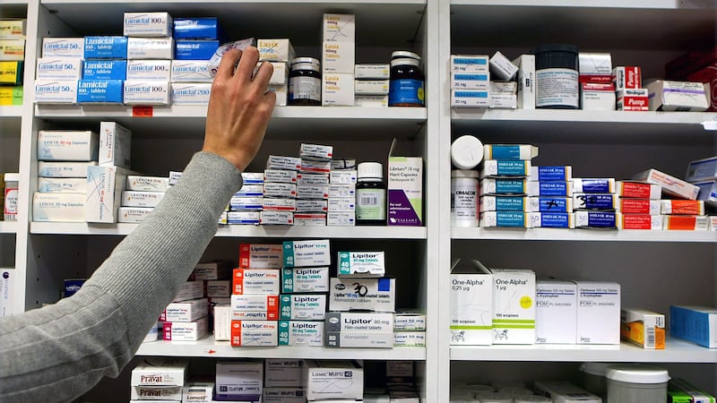 A pharmacist stocks shelves at a chemist (Julien Behal/PA).