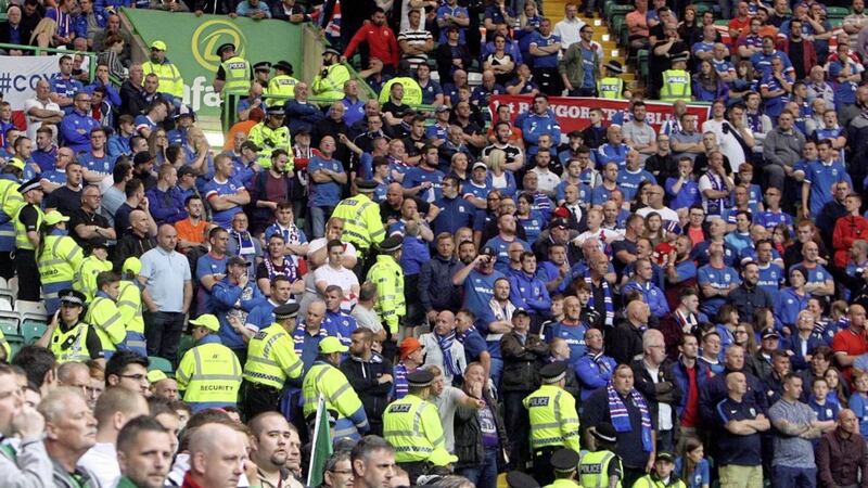 Police separate Linfield and Celtic supporters during the match at Celtic Park in Glasgow. Picture by Pacemaker