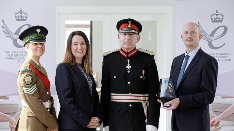 Shnuggle founders Adam and Sinead Murphy receive their Queen&#39;s Award from Co Down lord lieutenant David Lindsay, watched by Irish Guards cadet Sophie Ayres. Photo: Phil Smyth 