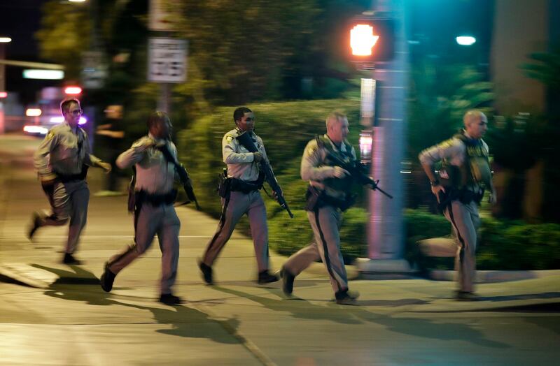 Blurred image of heavily armed police officers running