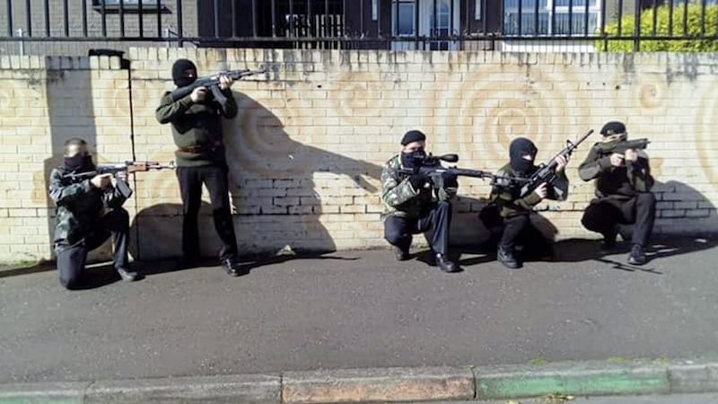 The band fundraiser saw masked men pose with imitation Armalite, Kalashnikov and Dragunov sniper rifles as well as an imitation stick grenade 