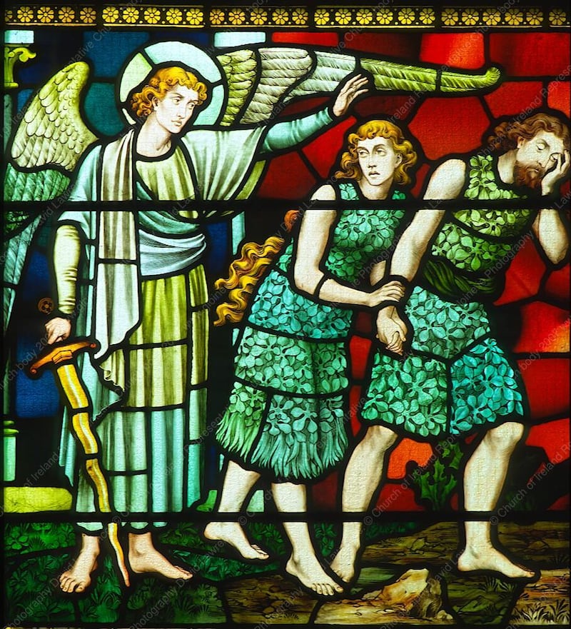 A stained glass depiction of the expulsion from the Garden of Eden in St Fin Barre's Cathedral in Cork