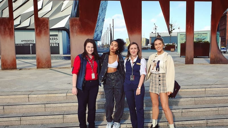 Little Mix's Leigh-Anne Pinnock (second from left) and Perrie Edwards (right) with staff from Titanic Belfast. Picture from Titantic Belfast on Twitter