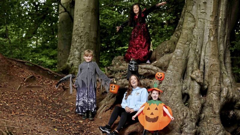 Colette McCartney, founder of Holistic Kidz, with Finn Jones and Susannah McCartney, both aged seven, and four-year-old Elle Brown at the launch the outdoor forest school&rsquo;s Halloween Camp which takes place from October 26-30 at Barnett Demesne in Belfast 