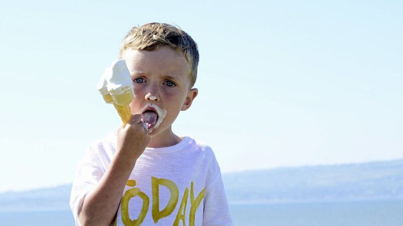 Four-year-old Thomas Sullivan from Belfast enjoying an ice-cream at Seapark beach near Holywood. Picture by Arthur Allison 