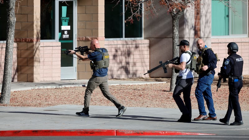 Law enforcement officers head into the University of Nevada (Steve Marcus/Las Vegas Sun via AP)
