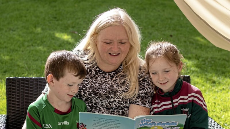 Yvonne Fleming reads one of her Weatherbies stories to her niece, Anna, and nephew, Danny. 