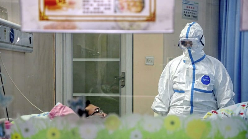 A doctor attends to a patient in an isolation ward at a hospital in Wuhan in central China&#39;s Hubei Province. PIcture by Chinatopix via AP 