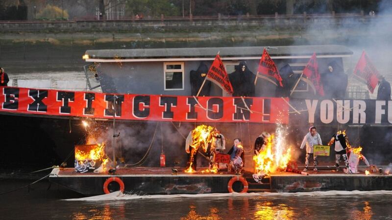 Joe Corre, the son of Vivienne Westwood and Sex Pistols creator Malcolm McLaren, burns his &pound;5 million punk collection on a boat on the River Thames in London. Picture by Dominic Lipinski, Press Association&nbsp;