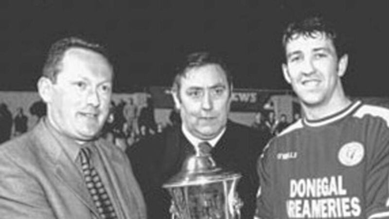 SAVOURING SUCCESS...Finn Harps captain Declan Boyle (right) receives the Irish News Cup from Irish News marketing executive Brendan Kerr (left) after the Donegal side defeated Ballymena United 2-0 in the final. Also present is North West Football Association chairman John McCrossan 