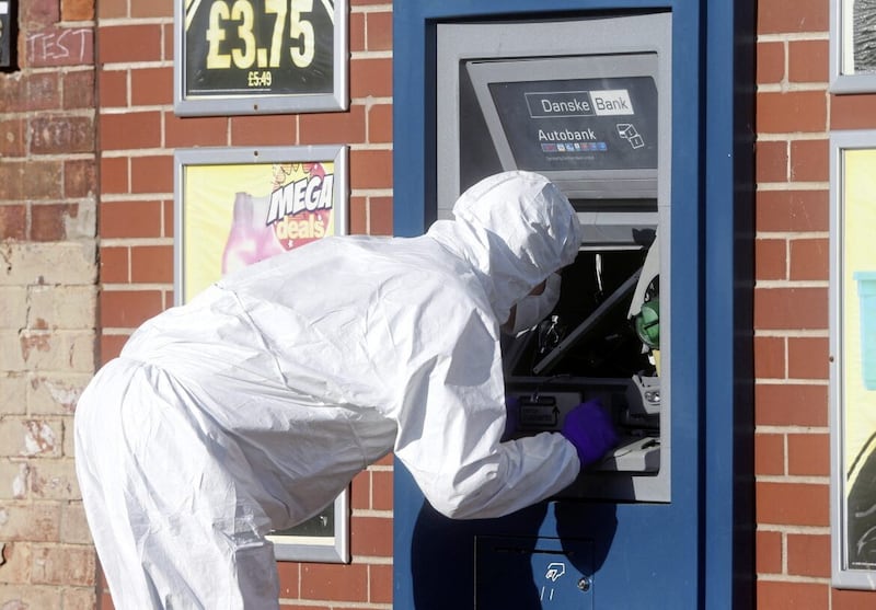 A forensic officer at the scene of an attempted ATM robbery. PIcture Mal McCann.