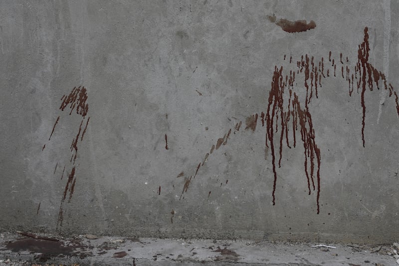 Blood covers a wall in the Petion-ville area of Port-au-Prince (Odelyn Joseph/AP)