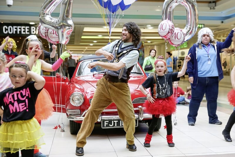 Former lord mayor of Armagh City, Banbridge &amp; Craigavon, Garath Keating, pictured dancing with local children to celebrate the 40th anniversary of Rushmere Shopping Centre. Picture by Philip Magowan. 