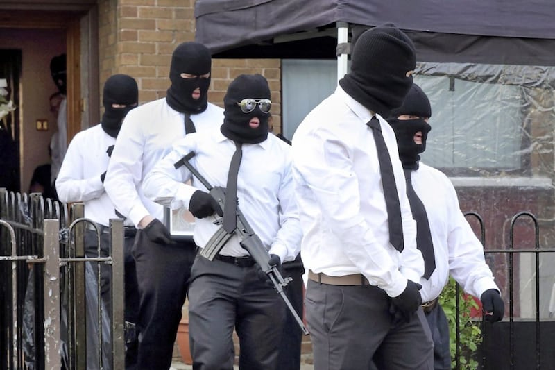 Masked gunmen fire a volley of shots outside the home of INLA man Martin McElkerney who died last week after a shooting incident in Milltown cemetery. Picture: Cliff Donaldson. 