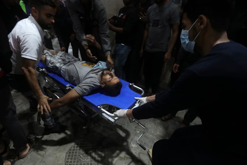 An injured Palestinian is brought to the Kuwaiti Hospital in Rafah refugee camp (AP Photo/Ismael Abu Dayyah)