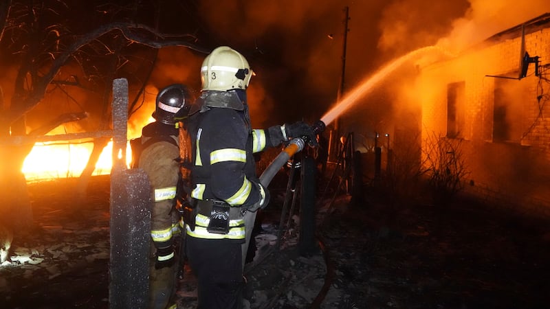 Firefighters extinguish a fire after a Russian attack on residential neighbourhood in Kharkiv (Andrii Marienko/AP)