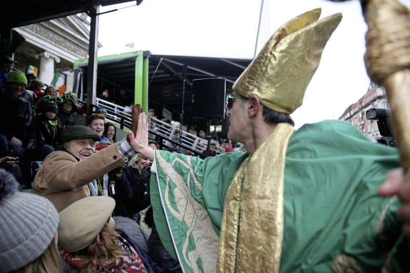 Mark Hamill high fives a man dressed as St Patrick during the St Patrick's day parade on the streets of Dublin. Picture by Brian Lawless/PA Wire