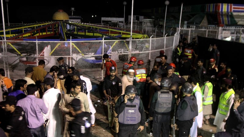 Pakistani police officers and rescue workers gather at the site of bomb explosion in a park in Lahore, Pakistan. Picture by KM&nbsp;Chuadary, Associated Press&nbsp;