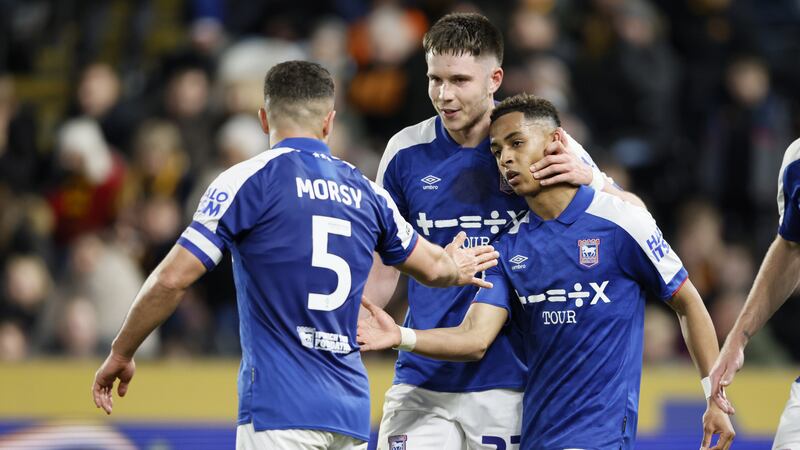 Omari Hutchinson, right, is congratulated by Sam Morsy, left, and George Hirst