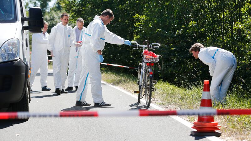 Criminal experts examine a bicycle that belonged to a man who was shot by a gunman in Germany &nbsp;