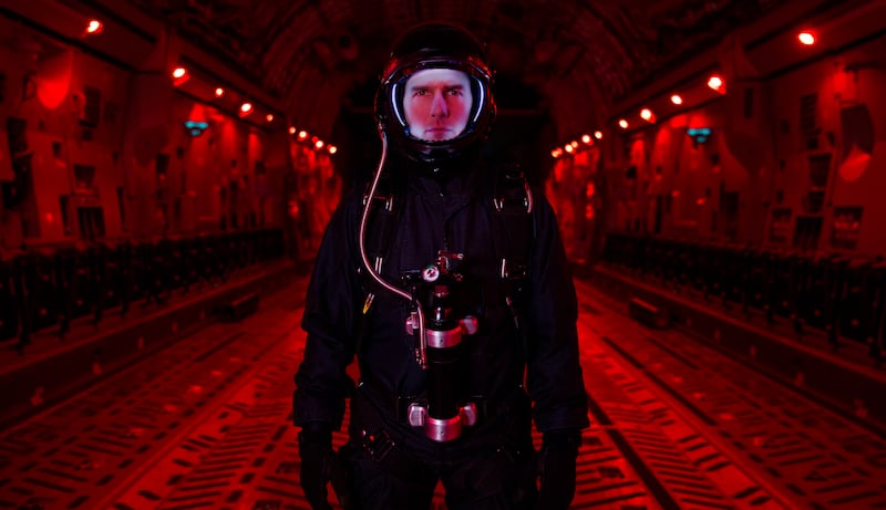 A photo of Tom Cruise in his Halo jump gear, bathed in red light, taken in the belly of a C17 transport plane by Mission: Impossible - Fallout unit stills photographer Chiabella James