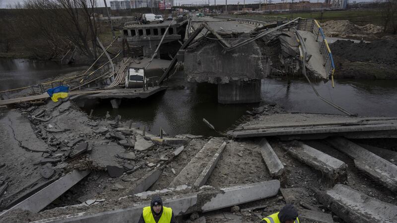 Engineers inspect the state of destruction of the bridge that connects Kyiv with Irpin, Ukraine, Wednesday, April 13, 2022 (AP Photo/Rodrigo Abd)&nbsp;