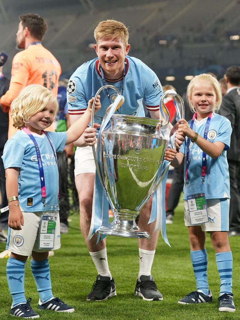 Manchester City’s Kevin De Bruyne poses with his children holding the Champions League trophy