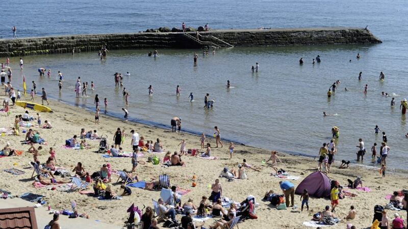 The recent spell of hot weather has contributed to an improvement in the UK&#39;s economy, according to official government figures 