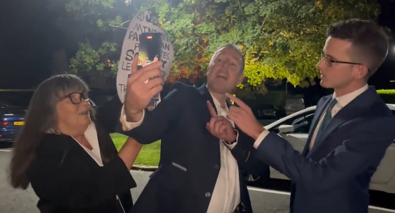 Photo shows Education Minister Paul Givan confronted at DUP conference by members of the Christian fundamentalist family of Enoch Burke. PICTURE: X: @EnochBurke