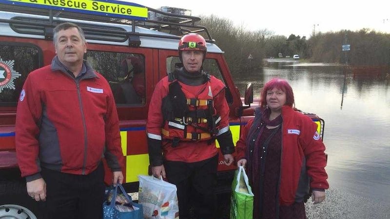 NIFRS Firefighter Nigel Quigley with volunteers from the Red Cross Neighbourhood Link Team provide support and assistance to the Fermanagh area, that has been badly affected by flooding. 