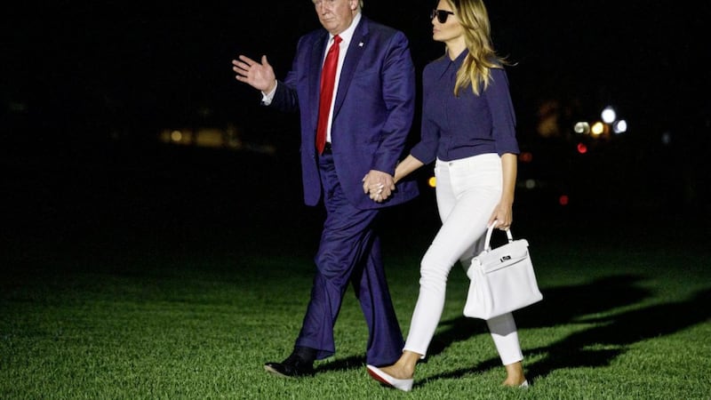 President Donald Trump and first lady Melania Trump walk from Marine One to the White House as they return from attending last week&#39;s G-7 summit in Biarritz 