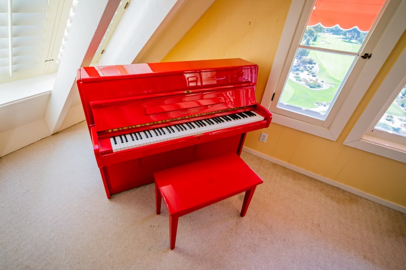 Day’s red lacquer Young Chang upright piano