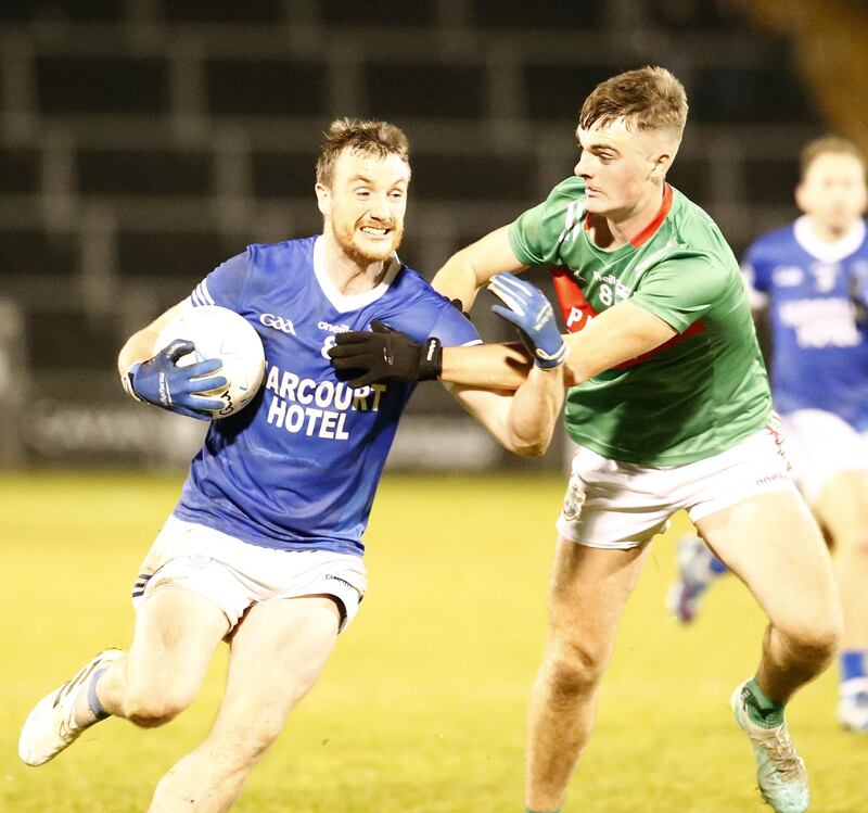Leo McLoone (left) battles past a Gowna opponent in the Ulster SFC quarter-final.